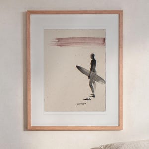 Surfer Ink Style print in a Red Oak frame with a white mat, hanging above the bedside table in a calm bedroom.