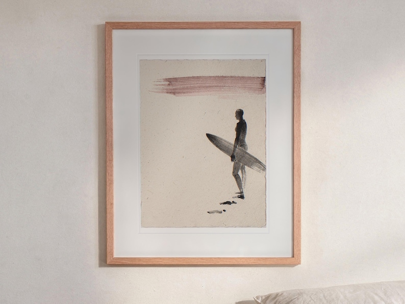 Surfer Ink Style print in a Red Oak frame with a white mat, hanging above the bedside table in a calm bedroom.
