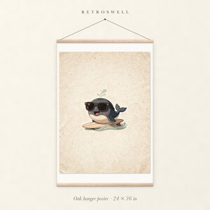 Whale Surfing oak hanger poster, 24 by 36 inches, with natural wood rails and a hanging cord.