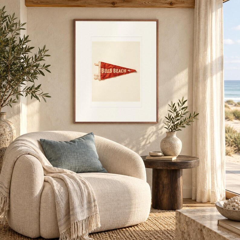 Bells Beach Surf Pennant print in a Red Oak frame with a white mat in a light-filled coastal sitting room.