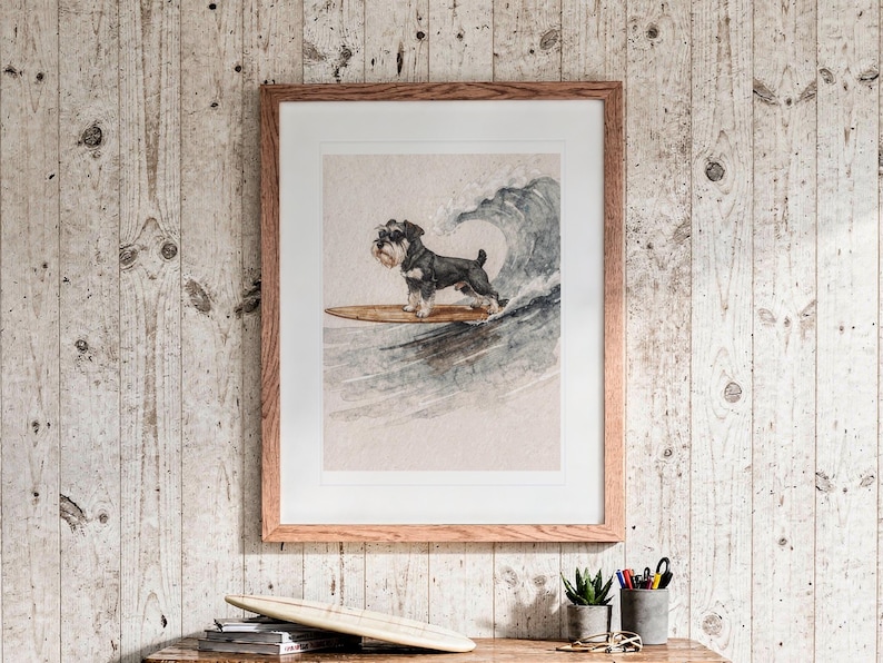 Miniature Schnauzer Surfing print in a Red Oak frame with a white mat, hanging above the dresser in a surf shack bedroom.