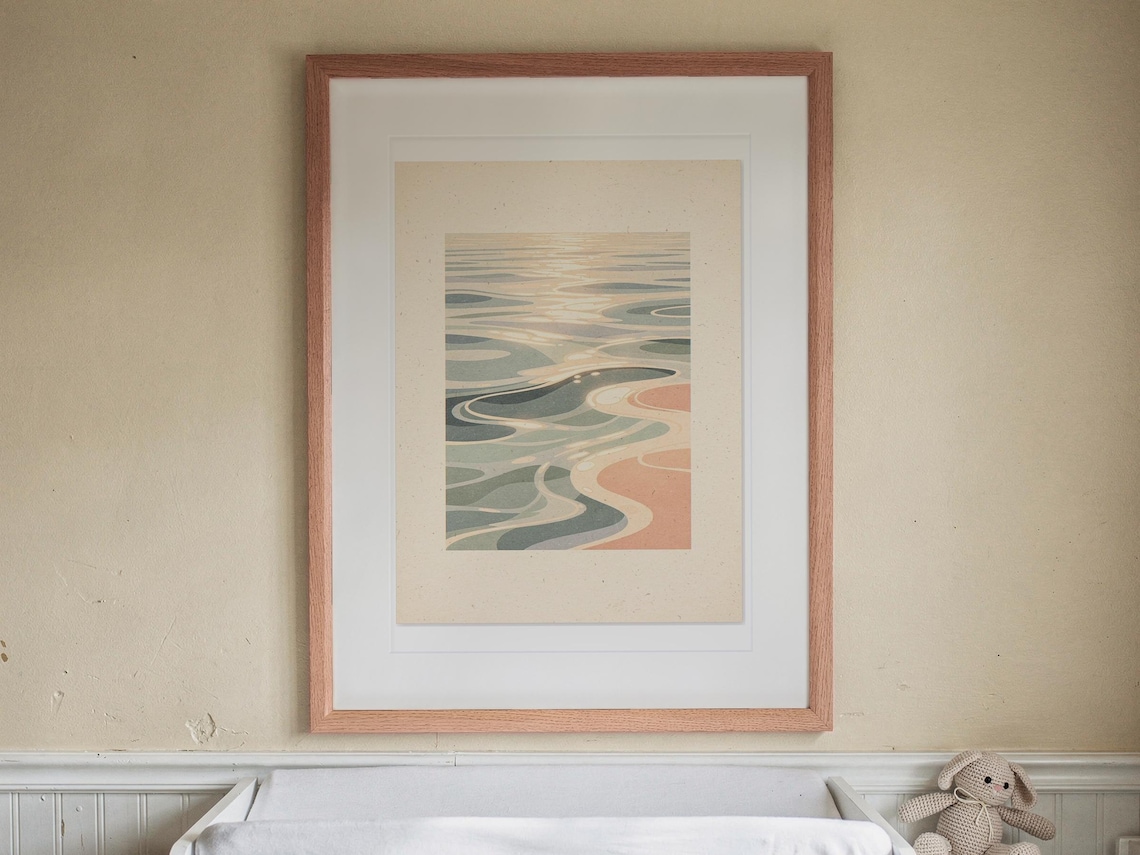 Pastel Ocean Ripples print in a Red Oak frame with a white mat, hanging above the dresser in a nursery.