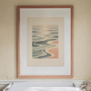Pastel Ocean Ripples print in a Red Oak frame with a white mat, hanging above the dresser in a nursery.