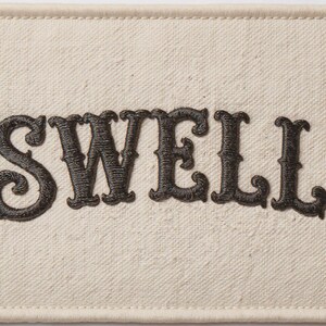 Swell Embroidered Patch Print framed in a modern bedroom setting