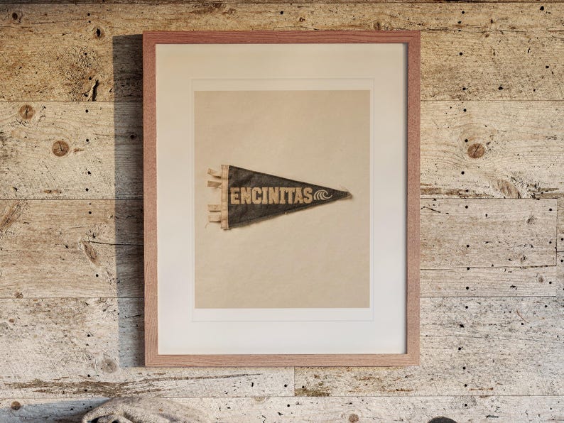 Encinitas print in a Red Oak frame with a white mat, hanging above the bench in a beach house loft.