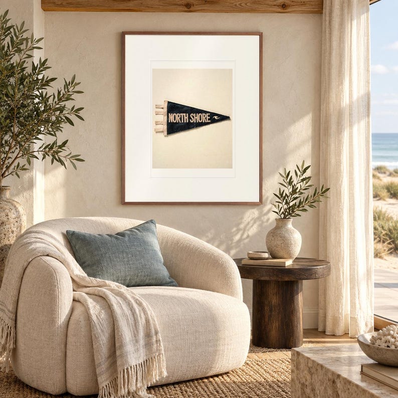 North Shore, Oahu Surf Pennant print in a Red Oak frame with a white mat in a light-filled coastal sitting room.