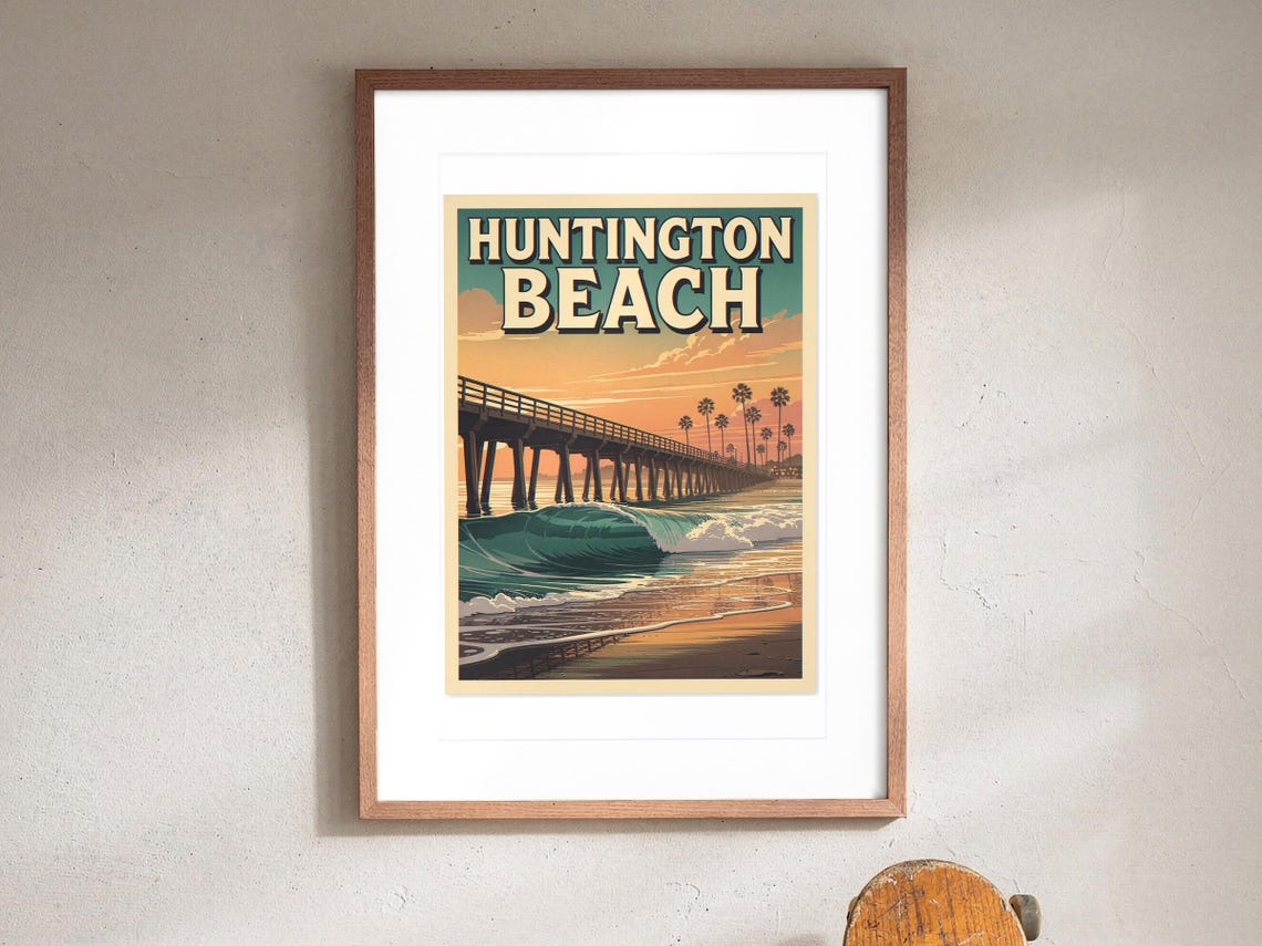 Huntington Beach Surf Travel Poster print in a Red Oak frame with a white mat, hanging above the console in a hallway.
