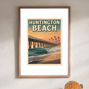 Huntington Beach Surf Travel Poster print in a Red Oak frame with a white mat, hanging above the console in a hallway.