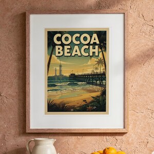 Cocoa Beach Surf Travel Poster print in a Red Oak frame with a white mat, hanging above the table in a boho living room.
