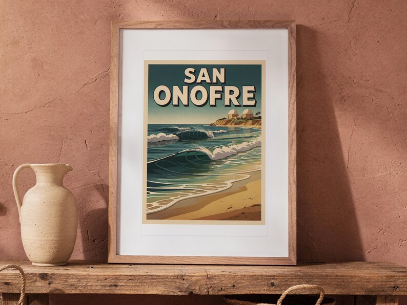 San Onofre Surf Travel Poster print in a Red Oak frame with a white mat, leaning on the bench against the wall in a boho living room.