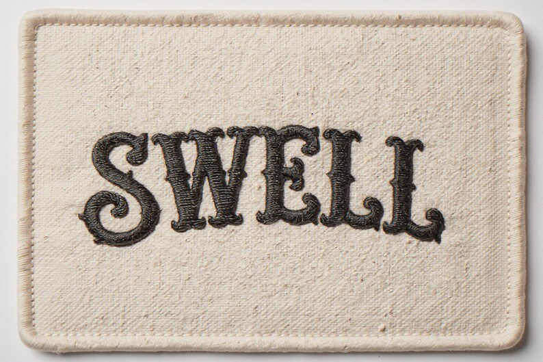 Swell Embroidered Patch Print framed in a beach-style living room setting