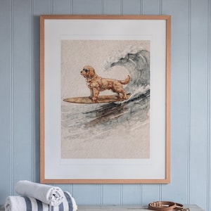 Goldendoodle Surfing print in a Red Oak frame with a white mat, hanging above the console in a beach cottage entryway.
