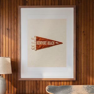 Newport Beach print in a Red Oak frame with a white mat, hanging above the credenza in a mid-century living room.