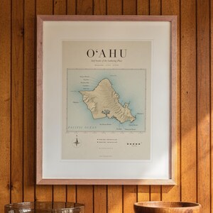 Oahu Surf Map printable art, shown printed in a Red Oak frame with a white mat, hanging above the credenza in a mid-century living room.