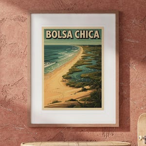 Bolsa Chica Surf Travel Poster print in a Red Oak frame with a white mat, hanging above the table in a boho living room.