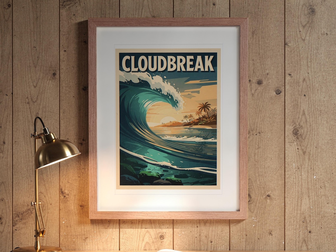 Cloudbreak Surf Travel Poster print in a Red Oak frame with a white mat, hanging above the desk in a home office.