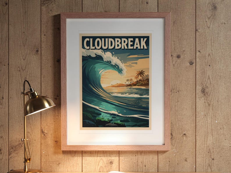 Cloudbreak Surf Travel Poster print in a Red Oak frame with a white mat, hanging above the desk in a home office.