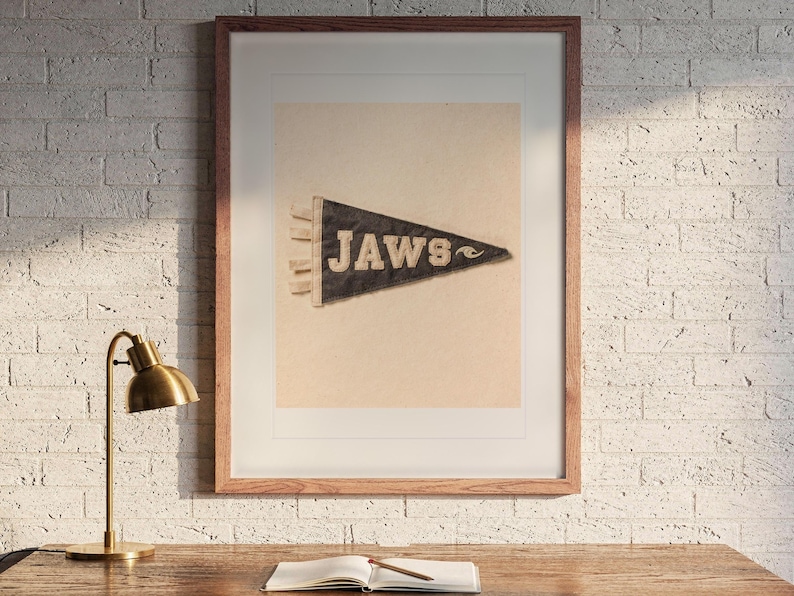 Jaws print in a Red Oak frame with a white mat, hanging above the desk in a home office.