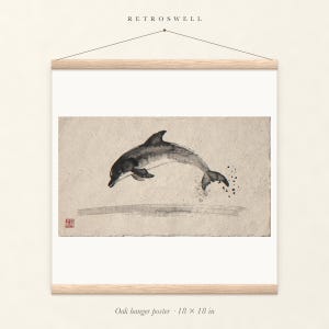 Leaping Dolphin Xieyi Ink oak hanger poster, 18 by 18 inches, the painting centred on the paper with natural wood rails and a hanging cord.