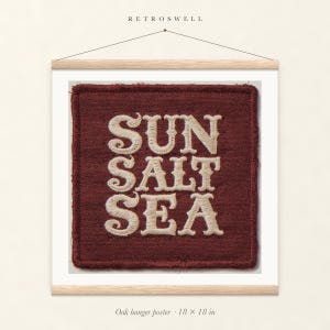 Sun Salt Sea Patch oak hanger poster, 18 by 18 inches, with natural wood rails and a hanging cord.