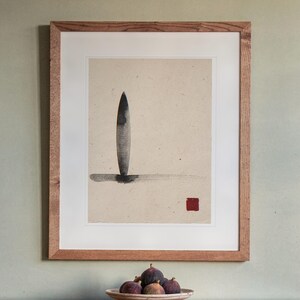 Longboard Ink Style print in a Red Oak frame with a white mat, hanging above the sideboard in a dining room.