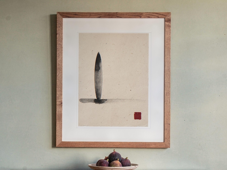 Longboard Ink Style print in a Red Oak frame with a white mat, hanging above the sideboard in a dining room.