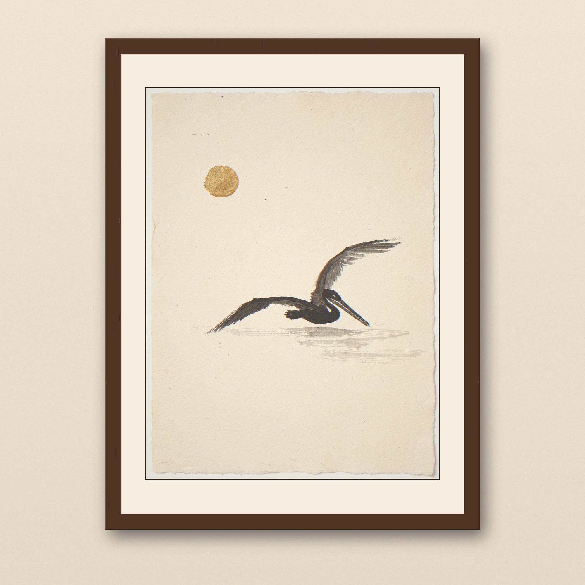 Sumi-e Pelican with Ochre Sun Accent Print - walnut framed art print with cream mat on plaster wall