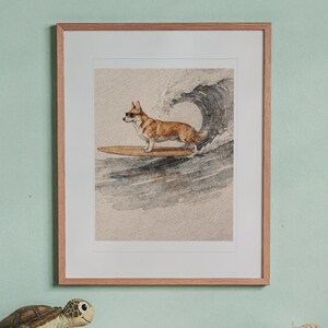 Corgi Surfing print in a Red Oak frame with a white mat, hanging above the desk in a kids' room.
