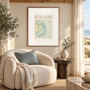 Outer Banks Surf Map print in a Red Oak frame with a white mat in a light-filled coastal sitting room.