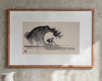 May include: A framed ink wash painting on textured paper depicting a surfer riding inside a large, dark, swirling wave. The artwork features expressive black brushstrokes, a light beige background, and a small red seal stamp in the corner.