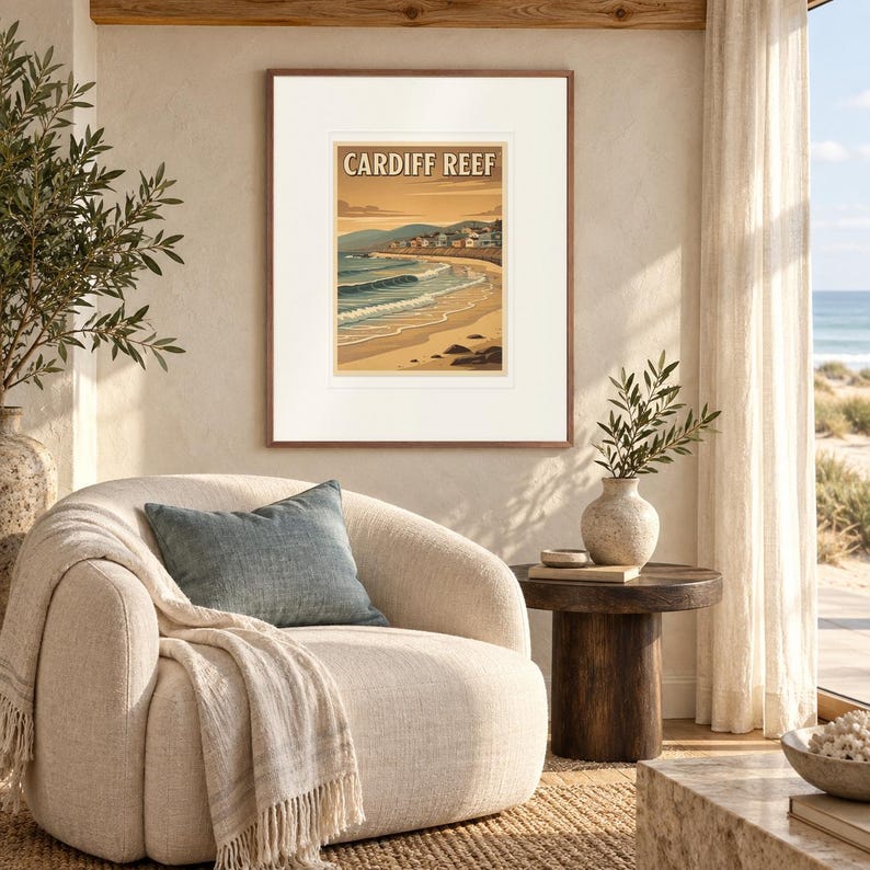 Cardiff Reef Surf print in a Red Oak frame with a white mat in a light-filled coastal sitting room.