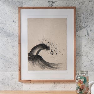 Breaking Wave Ink Style print in a Red Oak frame with a white mat, hanging above the vanity in a bright bathroom.