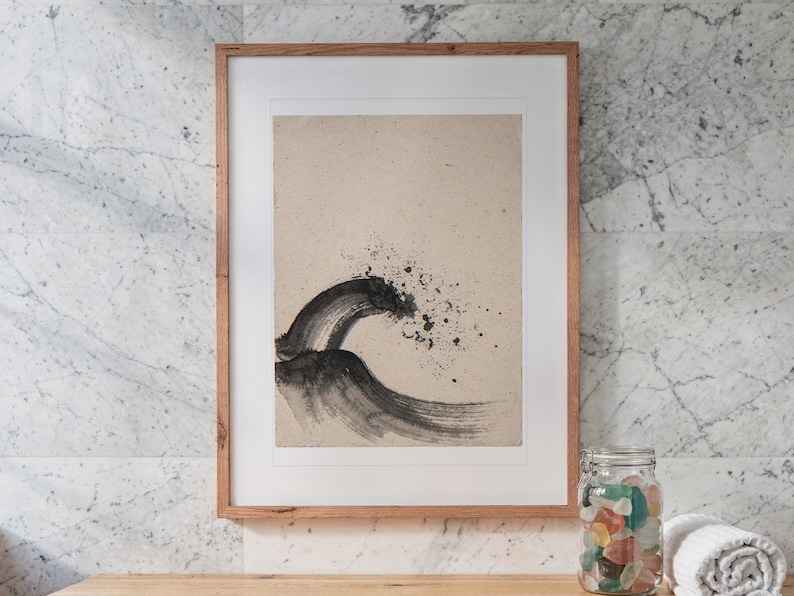 Breaking Wave Ink Style print in a Red Oak frame with a white mat, hanging above the vanity in a bright bathroom.