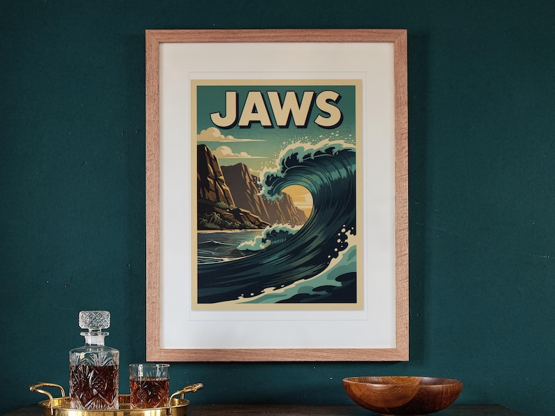 Jaws Maui Surf Travel Poster print in a Red Oak frame with a white mat, hanging above the sideboard in a green study.