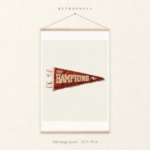The Hamptons, New York Surf Pennant oak hanger poster, 24 by 36 inches, with natural wood rails and a hanging cord.