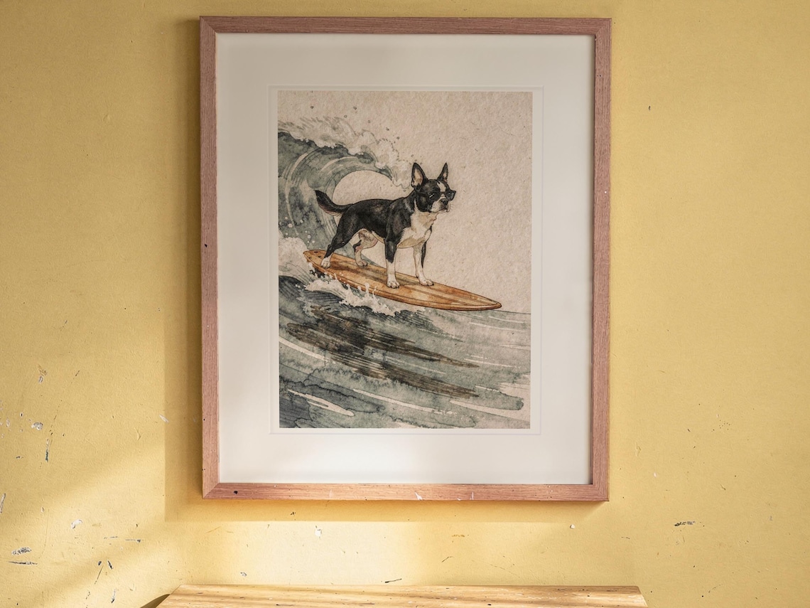 Boston Terrier Surfing print in a Red Oak frame with a white mat, hanging above the desk in a kids' room.