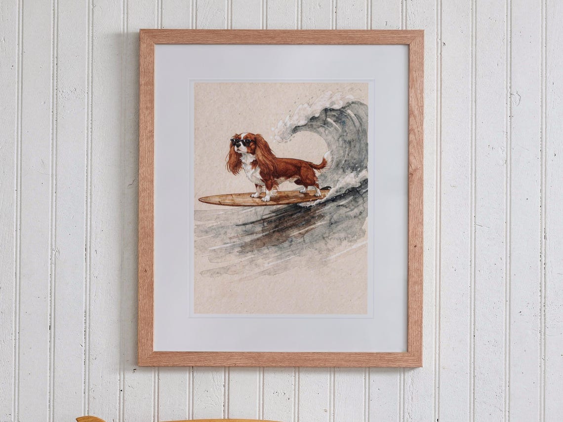 Cavalier King Charles Spaniel Surfing print in a Red Oak frame with a white mat, hanging above the bookshelf in a kids' room.