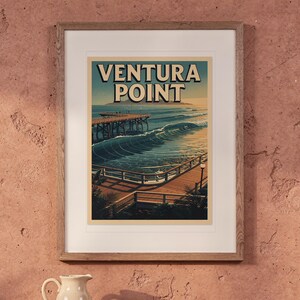 Ventura Point Surf Travel Poster print in a Red Oak frame with a white mat, hanging above the table in a boho living room.