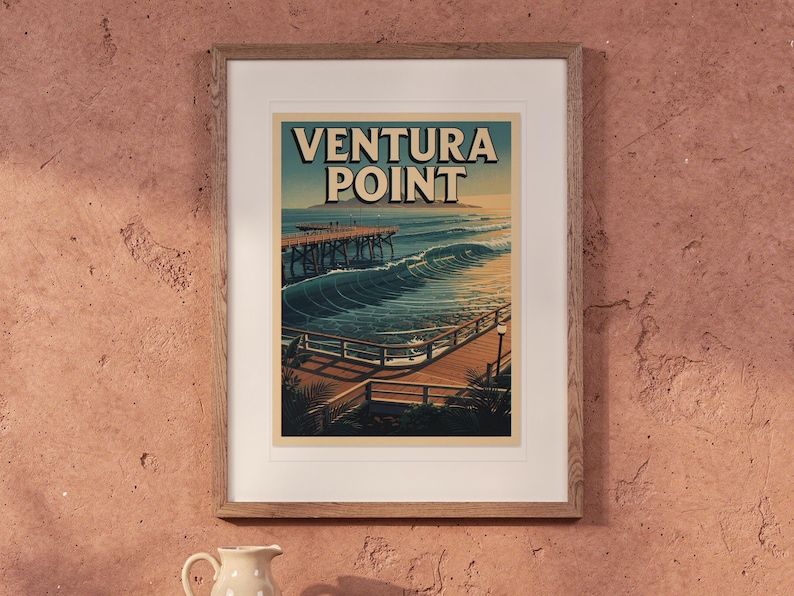 Ventura Point Surf Travel Poster print in a Red Oak frame with a white mat, hanging above the table in a boho living room.