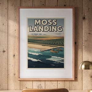Moss Landing Surf Travel Poster print in a Red Oak frame with a white mat, hanging above the desk in a home office.