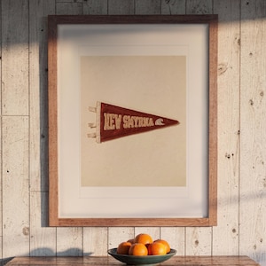New Smyrna Beach Surf Pennant print in a Red Oak frame with a white mat, hanging above the dresser in a surf shack bedroom.