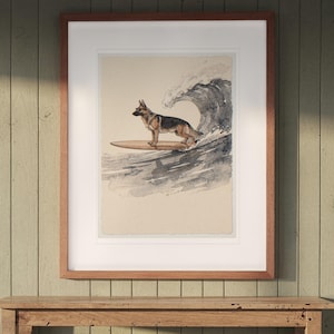 German Shepherd Surfing print in a Red Oak frame with a white mat, hanging above the console in a beach cottage entryway.