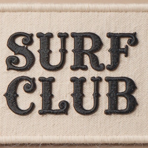 Surf Club Embroidered Patch Print framed in a beach-style living room setting