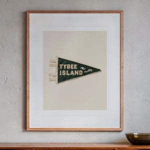 Tybee Island print in a Red Oak frame with a white mat, hanging above the credenza in a mid-century living room.