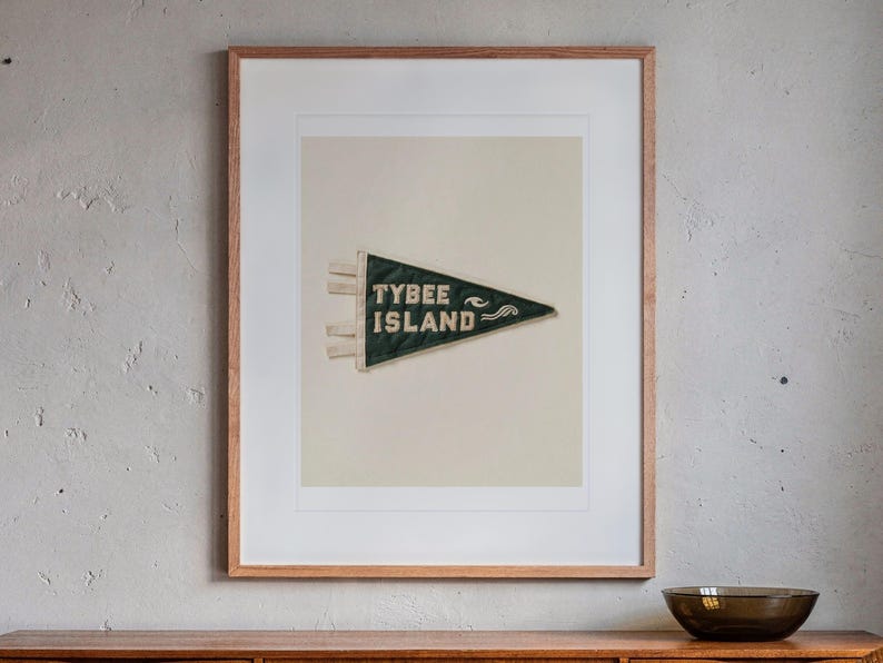 Tybee Island print in a Red Oak frame with a white mat, hanging above the credenza in a mid-century living room.