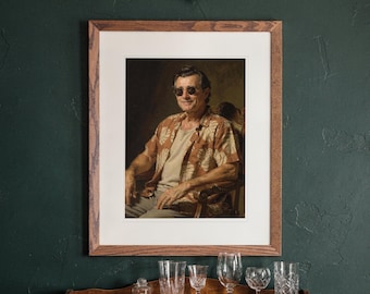 May include: A framed portrait print featuring a person wearing round sunglasses and a tan short-sleeved shirt with a white leaf pattern, seated in a wooden chair. The artwork is enclosed in a rectangular wooden frame with a white mat border.