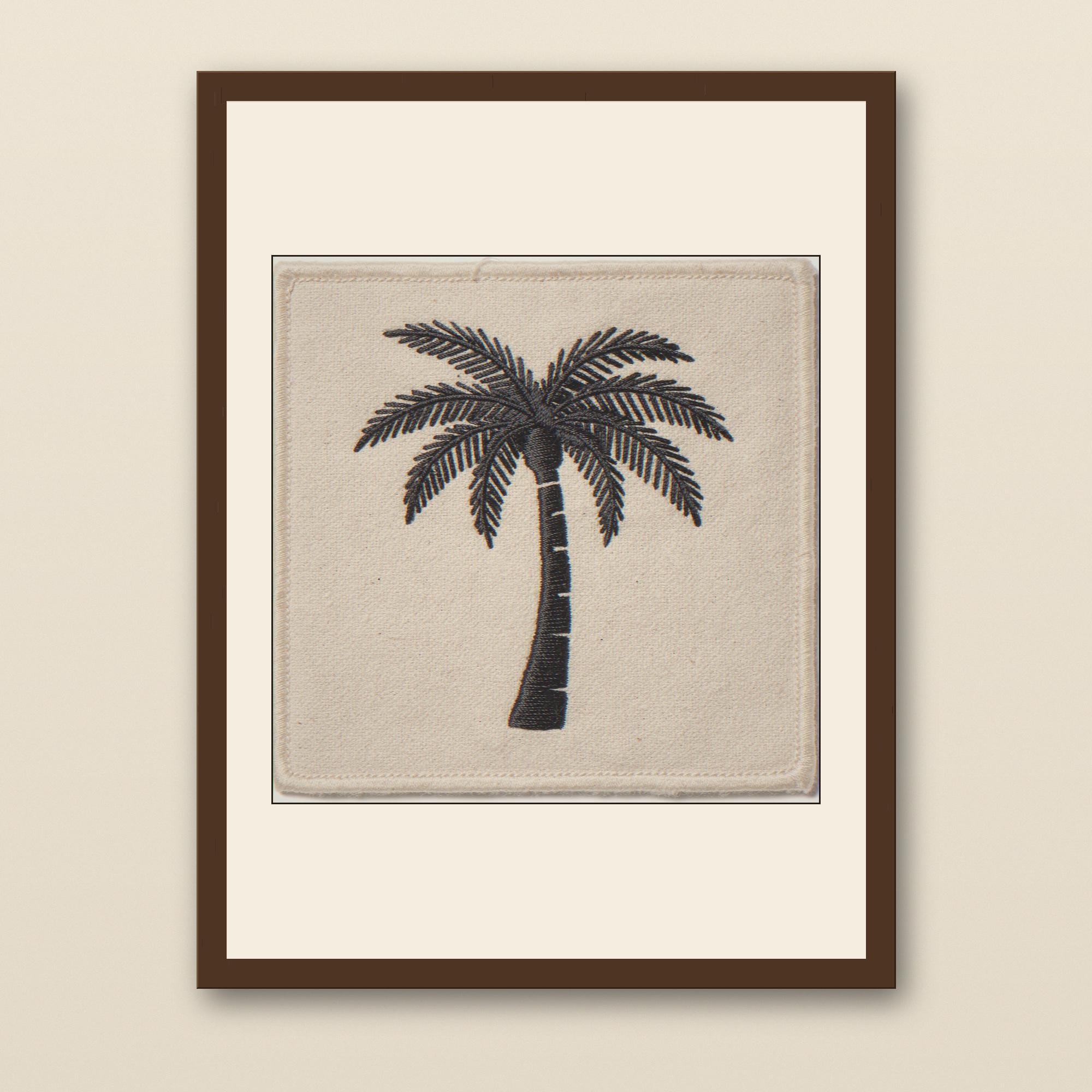 Palm Tree Embroidered Patch Print - walnut framed art print with cream mat on plaster wall