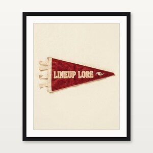 Lineup Lore coastal surf pennant art presented in a matte black gallery frame