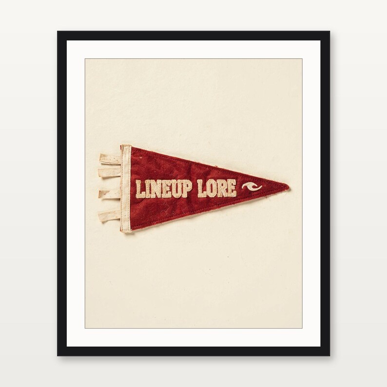 Lineup Lore coastal surf pennant art presented in a matte black gallery frame