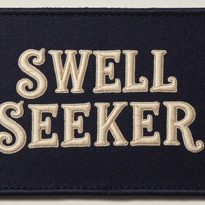 Swell Seeker Embroidered Patch Print framed in a coastal dining room setting